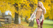 © weyo - Young woman in autumn outfit emotional walk in park