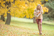 © weyo - Young woman in autumn outfit emotional walk in park