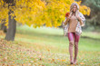 © weyo - Young woman in autumn outfit emotional walk in park