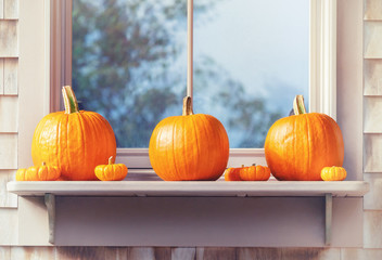 Wall Mural - Beautiful outdoor display of pumpkins on window sill