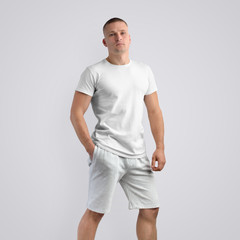 Sticker - Muscular young caucasian man in a blank T-shirt on a white studio background.