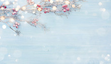 Snowy Branch With Red Berries Over Abstract Blue Wooden Background