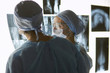 © lenetsnikolai - Two female women medical doctors looking at x-rays in a hospital