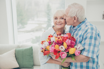 Wall Mural - Portrait of her she his he two nice lovely cheerful cheery sweet tender people granny receiving big fresh floral tulips congrats greetings spring springtime in light white interior living-room house