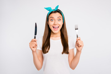 Close-up portrait of her she nice attractive lovely charming ecstatic cheerful cheery girl holding in hands fork knife positive changes nutrition isolated over light white color background