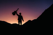© Andriy - Silhouette of a man holding a guitar on a background of mountains and sunset. Concept of freedom relaxation. Place for text or advertising