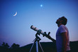 Astronomer with a telescope watching at the stars and Moon. My astronomy work.