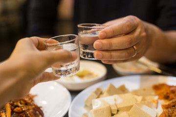 Cheers with soju. Korean popular alcholic drink