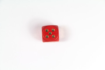 Red dice stopped on the number five on white background