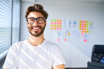 Portrait of young startup entreprener standing in office