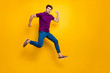 © deagreez - Full length body size turned photo of surprised man running as fast as he can towards shopping mall to come for sales on time wearing blue pants trousers shoes isolated vivid color background