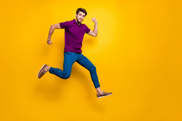 Full length body size turned photo of surprised man running as fast as he can towards shopping mall to come for sales on time wearing blue pants trousers shoes isolated vivid color background