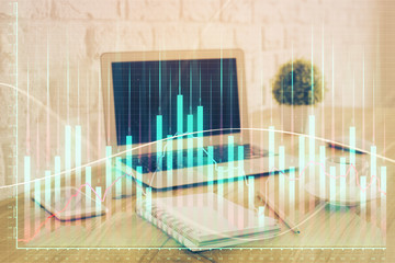 Stock market chart hologram drawn on personal computer background. Multi exposure. Concept of investment.