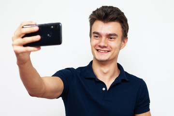 Wall Mural - young man with mobile phone taking a selfie