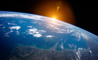 Wall Mural - view of planet earth close up with atmosphere during a sunrise 3d rendering elements of this image f
