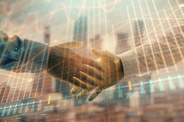 double exposure of financial graph on cityscape background with two businessman handshake. concept o