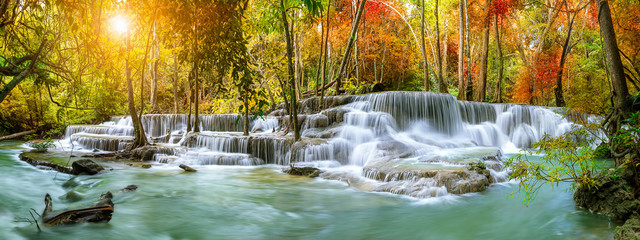 colorful majestic waterfall in national park forest during autumn, panorama - image