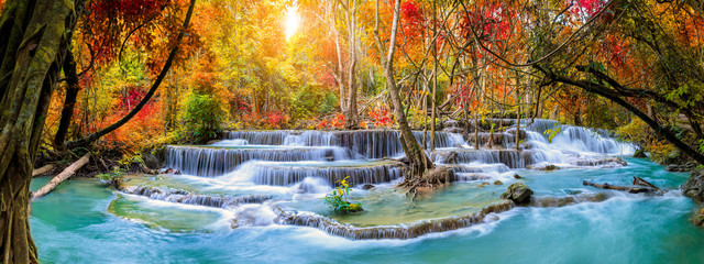 Wall Mural - Colorful majestic waterfall in national park forest during autumn, panorama - Image