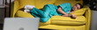 © LIGHTFIELD STUDIOS - panoramic shot of attractive nurse in uniform sleeping on yellow sofa during night shift