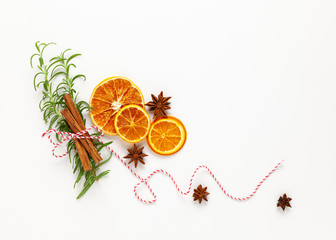 Wall Mural -  Christmas composition with dried oranges and spices on white background. Natural food ingredient for cooking or Christmas decor for home. Flat lay.