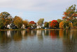 Beautiful autumn Midwest nature background.Fall view of private houses neighborhood with classic American middle class homes and colorful trees along a pond reflected in a water.Tenney Park,Madison,WI