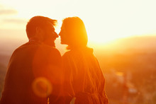 Romantic Couple Enjoying Together On Romantic Sunset.