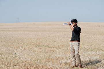 South asian agronomist farmer inspecting wheat field farm. Agriculture production concept.