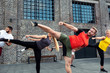 © didesign - Group of people performing leg kicks