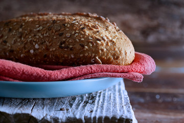 Homemade  whole wheat rustic bread on wooden table. 