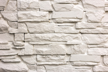 Wall Mural - Close-up of white solid limestone wall or stone fence. Abstract copy space background, Bricklaying, construction and masonry concept.