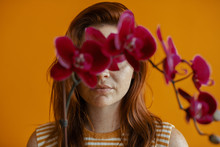 Woman With An Orchid Covering Eyes