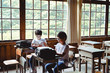 © Taishi Arashida - Two young boys with glasses sitting at desks in classroom