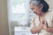 © suphaporn - Senior female Asian suffering from bad pain in his chest heart attack at home - senior heart disease