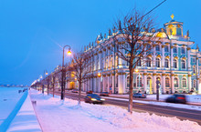 St. Petersburg In The Christmas Holidays. View Of The Snowy Neva River And The Palace Embankment In Snowy Evening