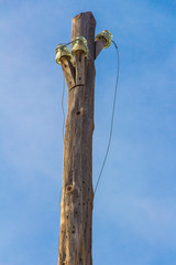 vintage power lines on a wooden pole, power line column, abandoned pole, vintage wooden pole