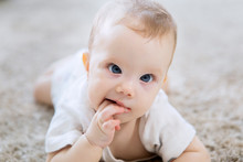 Cute Caucasian Girl Baby Crawling On The Carpet