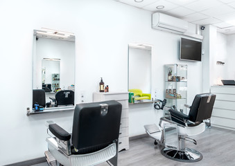 Modern bright hair and beauty salon. Barber salon interior business with black and white luxury decor.