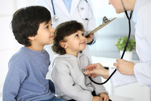 Doctor Examining A Child Patient By Stethoscope. Cute Arab Boy At Physician Appointment. Medicine And Healthcare Concept
