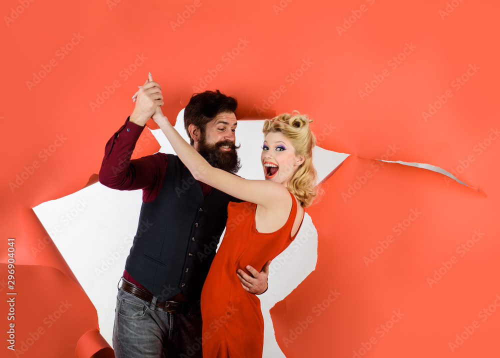 Happy couple enjoying dance. Cute young couple dancing. Stylish couple dancing. Dancing people in dance class. Romantic couple dance together at dance hall. Pretty woman and bearded man dancing. - obrazy, fototapety, plakaty 