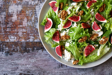 Wall Mural - Green salad with figs and white cheese. Keto salad. Keto diet.