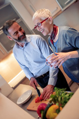 Wall Mural - Mature couple cooking together at home