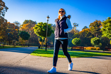 Wall Mural - middle-aged woman walking in city park