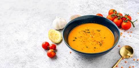 Wall Mural - A blue plate with red lentil soup with vegetables