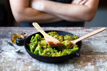 Chef mixes broccoli in a pan. Cooking broccoli. Healthy food.