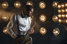 Male Jazzman Plays The Saxophone On Stage