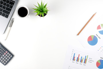 Wall Mural - Work space white office table desk with business graph documents and calculator, Laptop and supplies, Flat lay, Top view with copy space