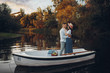 © Nomad_Soul - Lovers hugs in a boat on quiet lake at summer day
