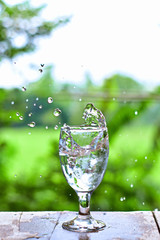 Water splashes in a glass of water on the table