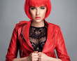 Beautiful sexy woman with bright red bob hairstyle. Fashion  model. Sensual  gorgeous girl in a leather jacket. Stunning face of a pretty lady.