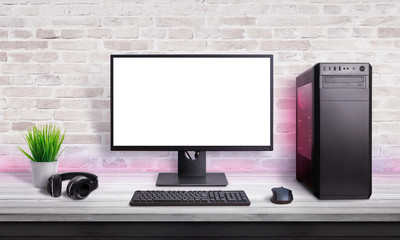 Gamer PC on desk with isolated screen for app, web site or game promotion. Modern case with RGB light, mouse, keyboard and headphones.